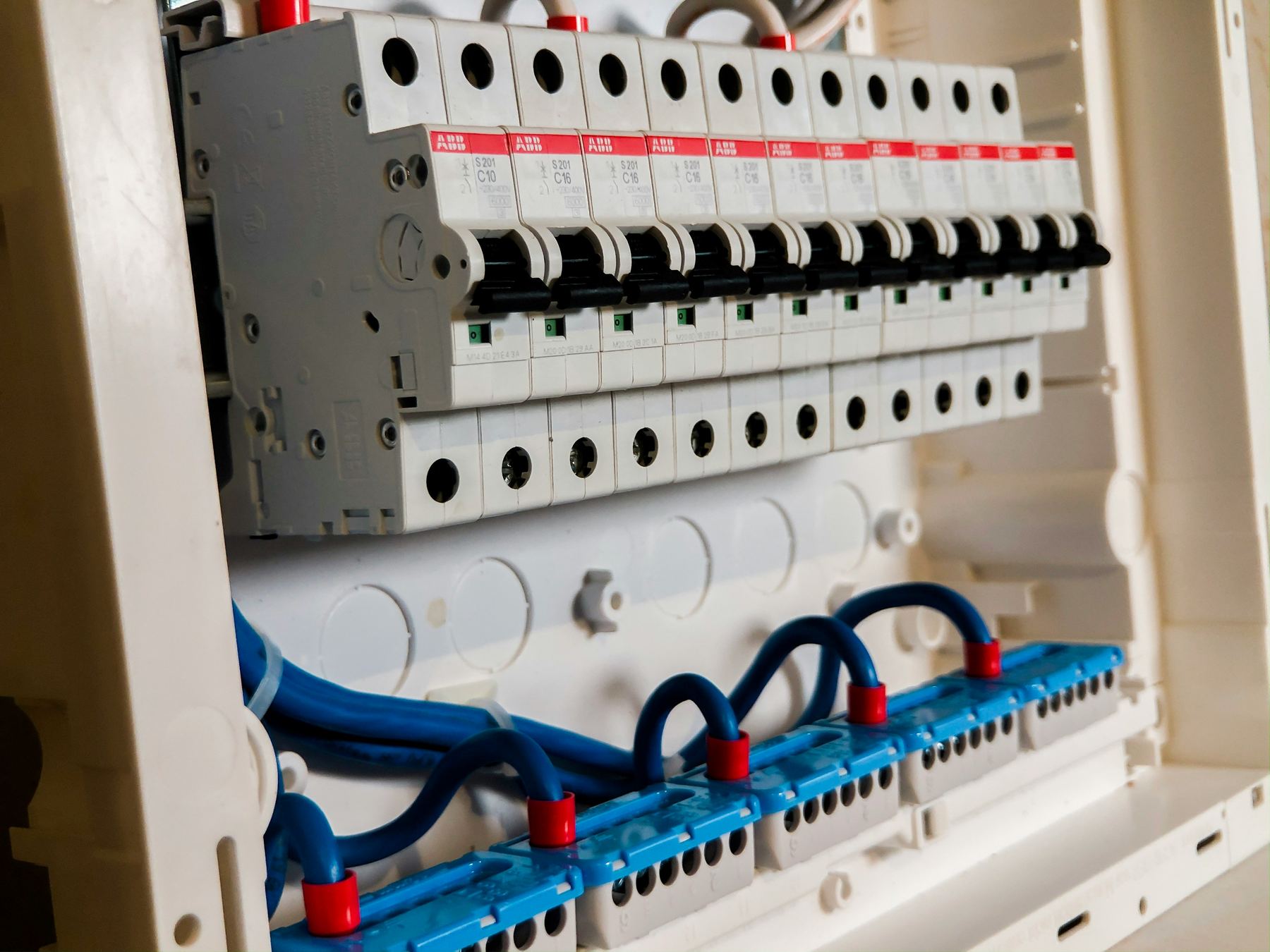 Electrician wiring a consumer unit in a Glasgow property